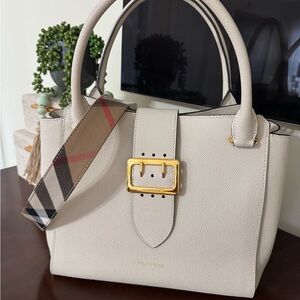 Burberry cream buckle tote with strap, tags and dust bag